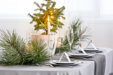 Dining table with beautiful setting in living room decorated for Christmas eve
