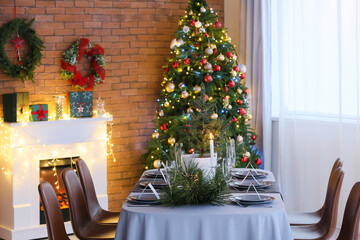 Dining table with beautiful setting in living room decorated for Christmas eve