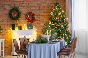 Dining table with beautiful setting in living room decorated for Christmas eve