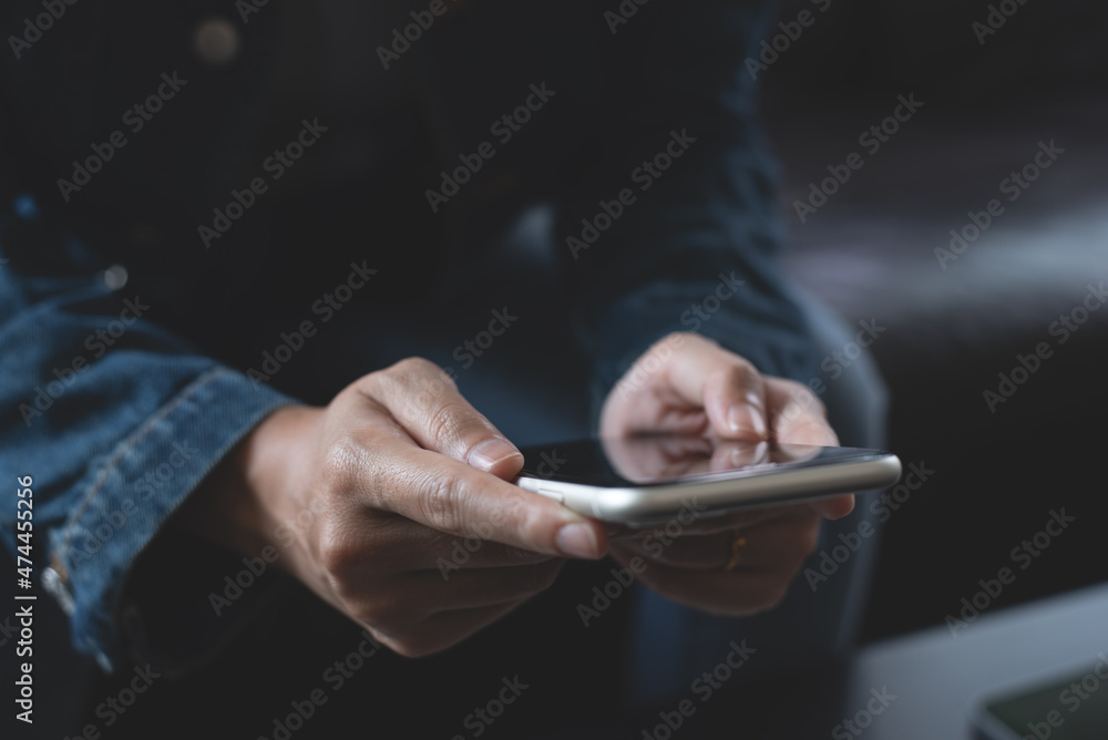 Poster woman sitting on sofa at home using smart mobile phone for online shopping or social media connectin