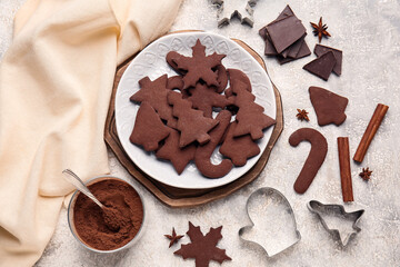 Plate with tasty chocolate Christmas cookies on light background
