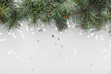 Beautiful confetti with fir branches on grey background