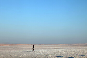 Fototapeta na wymiar People walking at Salt Lake in Aksaray, Turkey. Salt Lake is the second largest lake in Turkey with its 1665 km2.