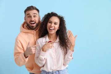 Obraz premium Happy engaged young couple after marriage proposal on color background