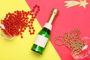 Composition with bottle of champagne and glasses and beads on color background