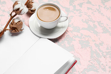 Cup of tasty coffee, book and cotton flowers on light background