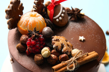 Tasty Christmas chocolate cake on color background, closeup