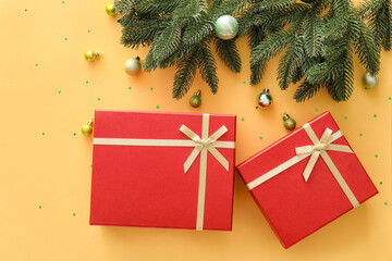Composition with Christmas gift boxes, balls and fir branches on beige background