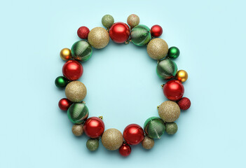 Frame made of different Christmas balls on blue background