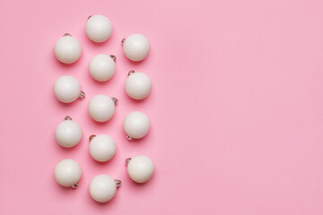 White Christmas balls on pink background