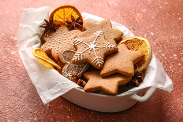 Basket with sweet Christmas gingerbread cookies on red background