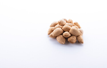 Heap of  Almond nuts isolated on white background, close-up.