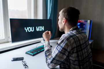 person playing video game showing happy emotions winning the game