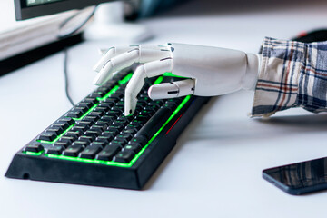robot hand type the text on the computer keyboard