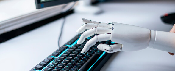 robot hand type the text on the computer keyboard