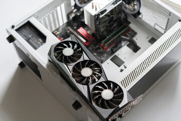 new modern powerful computer video or graphics card installed in computer by serviceman