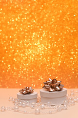 two beautiful gift boxes on a shiny gold bokeh background. vertical photo.