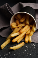 French fries in a glass with coarse salt.