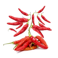 Fotobehang Fresh red chilies scattered in the air on a white background. photo of chili for sauce and spicy food products © Bobby Syahronanda