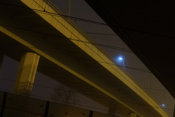 street lights under a concrete bridge in the fog in the city of Prague at night 2021