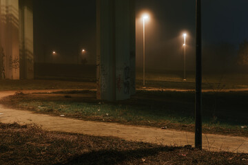 street lights under a concrete bridge in the fog in the city of Prague at night 2021