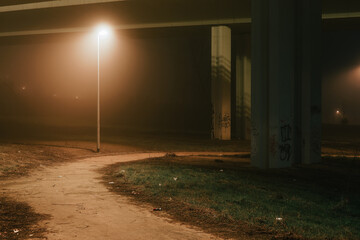 street lights under a concrete bridge in the fog in the city of Prague at night 2021