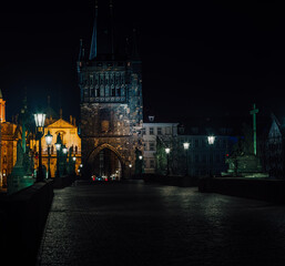 Fototapeta premium street lamps and old tower on Charles Bridge in the city of Prague at night 2021