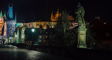 Obraz premium street lamps and old tower on Charles Bridge in the city of Prague at night 2021