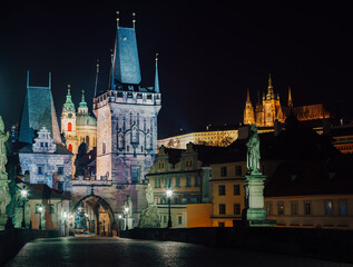 Fototapeta na wymiar street lamps and old tower on Charles Bridge in the city of Prague at night 2021