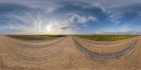 Full spherical seamless hdri 360 panorama on no traffic yellow sand gravel road among fields with sunny day and awesome clouds sky in equirectangular projection, VR AR content
