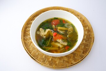 Boiled tilapia in white bowl on bamboo isolated on white background.