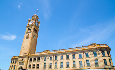 Iconic clock tower building at Sydney Central railway station with blue sky at the background.