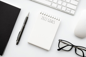 Notebook with 2022 goals text on it to apply new year resolutions and plan.