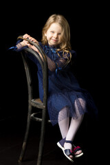 Fototapeta na wymiar Close up portrait of happy sitting little girl