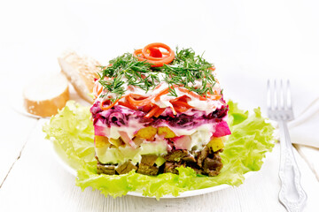 Salad with beef and vegetables on light board