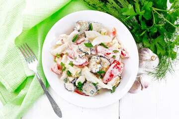 Salad with fried zucchini in plate on board top