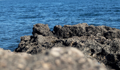 frozen lava on the background of the sea