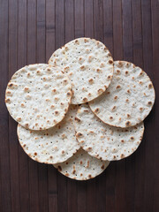 Round crispbreads on wooden background
