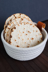 Round Crispbreads in a textile basket on dark background