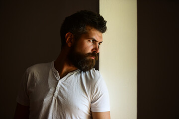 Confident attractive man with serious face. Shadow male face.