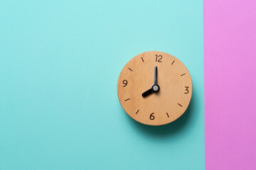 Retro alarm clock on green and pink table, vintage style