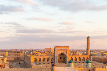 Fototapeta premium Beautiful view from Kunya Ark Citadel on the Mohammed Rakhim Khan Madrassah. Ichan Kala (or Itchan Qala is walled inner town of the city of Khiva, a UNESCO World Heritage Site), Khiva city, Uzbekistan