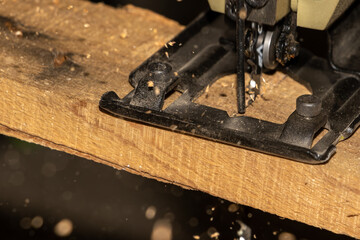 jigsaw is cutting timber with wood chips