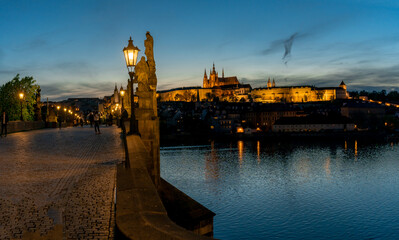 lamp on Charles Bridge on Vltava River and in the background Prague Castle and St. Vitus Cathedral...