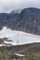 Glacier at a mountains and clouds at the  peak