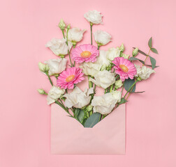 White eustoma flowers and pink dasy in pink envelope on pink baclground. Romantic floral background.