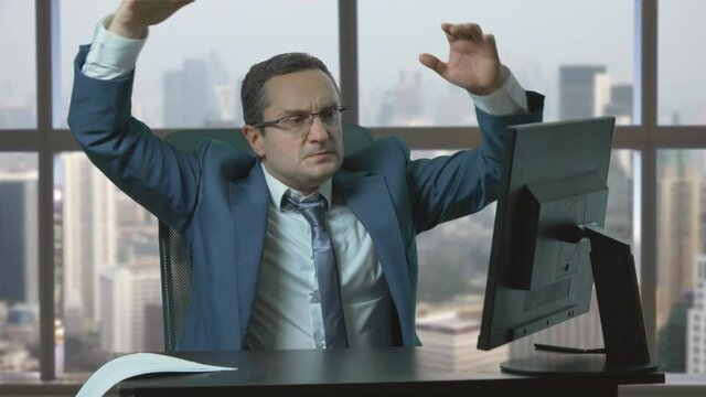 Angry businessman work at computer, Nervous man throws things off the desk, failure