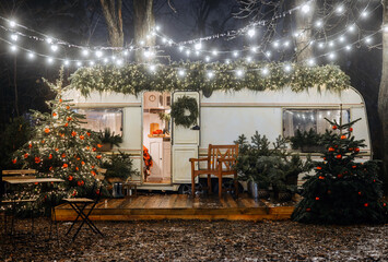 Mobile home Caravan with terrace at night, Mobile home decorated with Christmas decor. Festive...