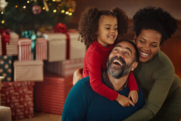 Parents and daughter during Christmastime at home