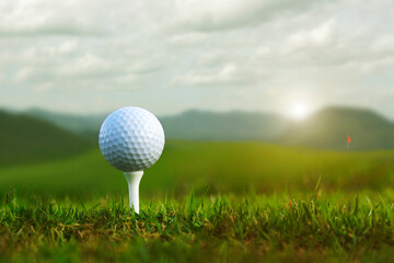 golf ball on tee in a beautiful golf course with morning sunshine